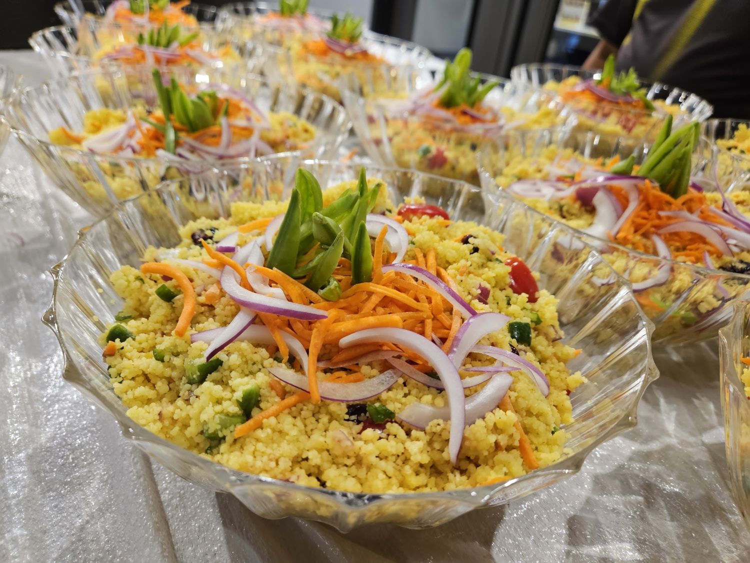 Bowls of yellow rice topped with vegetables